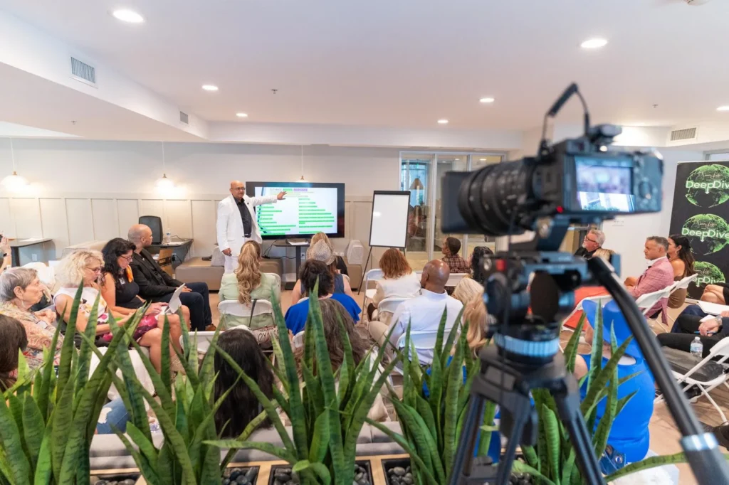 Dr. Sal’s gut-health seminar being filmed, audience seated in rows